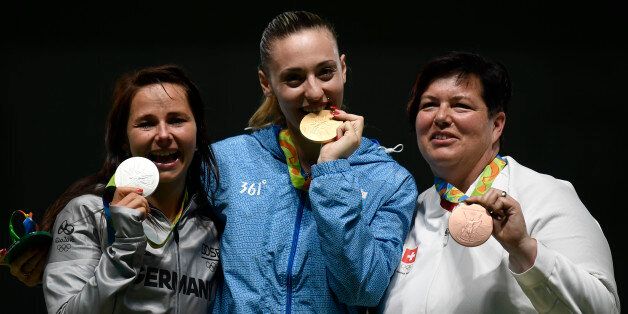 (L to R) Silver medallist Germany's Monika Karsch, gold medallist Greece's Anna Korakaki and bronze medallist Switzerland's Heidi Diethelm Gerber pose on the podium of the 25m pistol women shooting event at the Rio 2016 Olympic Games at the Olympic Shooting Centre in Rio de Janeiro on August 9, 2016. / AFP / PHILIPPE LOPEZ (Photo credit should read PHILIPPE LOPEZ/AFP/Getty Images)