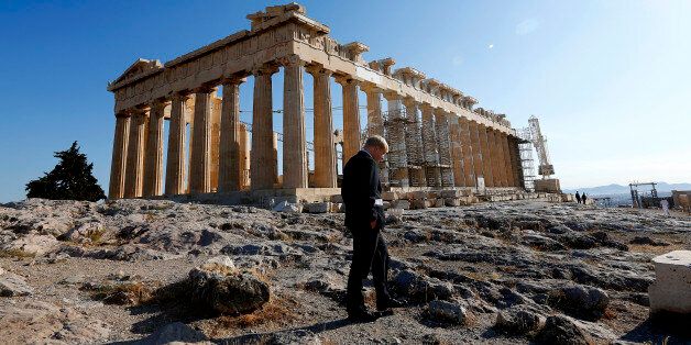 Mayor of London Boris Johnson walks by the temple of Parthenon after an Olympic Flame ceremony atop the Athens Acropolis May 16, 2012 during a ceremony. The Olympic flame will be handed over to the London 2012 delegation on Thursday. REUTERS/Yannis Behrakis (GREECE - Tags: SPORT OLYMPICS)