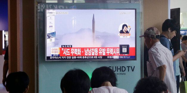 South Koreans watch a TV news program airing file footage of a North Korean rocket launch at the Seoul Railway Station in Seoul, South Korea, Wednesday, Aug. 3, 2016. North Korea fired a ballistic missile into the sea on Wednesday, South Korea's military said, the fourth reported weapons launch the North has carried out in about two weeks. The characters read