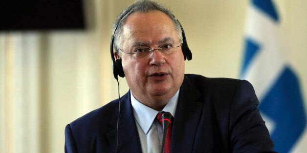 Greek Foreign Minister Nikos Kotzias speaks at a press conference with his Iranian counterpart Mohammad Javad Zarif in Tehran, Iran, Sunday, Nov. 29, 2015. (AP Photo/Vahid Salemi)