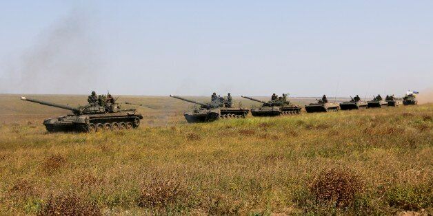 A column of Ukrainian tanks and APCs move towards the de-facto border with Crimea near Kherson, southern Ukraine, Friday, Aug. 12, 2016. Ukraine put its troops on combat alert Thursday along the country's de-facto borders with Crimea and separatist rebels in the east amid an escalating war of words with Russia over Crimea. (AP Photo/Aleksandr Shulman)