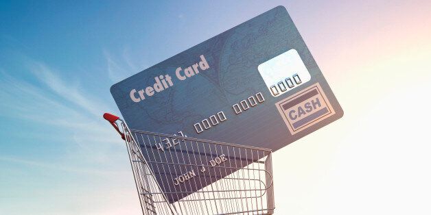 Large credit card in shopping cart in parking lot