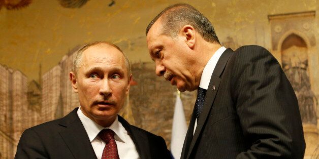 Russia's President Vladimir Putin (L) and Turkey's Prime Minister Tayyip Erdogan chat following a news conference in Istanbul December 3, 2012. REUTERS/Murad Sezer (TURKEY - Tags: POLITICS)