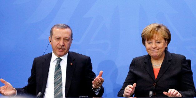 German Chancellor Angela Merkel and Turkey's Prime Minister Tayyip Erdogan address the media after talks in Berlin February 4, 2014. REUTERS/Tobias Schwarz (GERMANY - Tags: POLITICS)