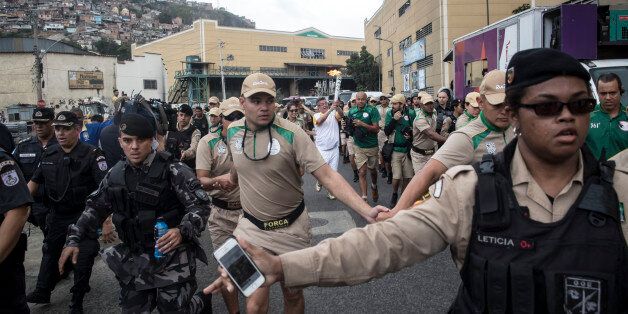 RIO DE JANEIRO, BRAZIL- AUGUST 03:Brazillian police and military surrounded the Olympic torch relay entourage as they made their way from Cidade do Samba in central Rio de Janeiro Wednesday morning.Lucas Oleniuk-Toronto Star (Lucas Oleniuk/Toronto Star via Getty Images)