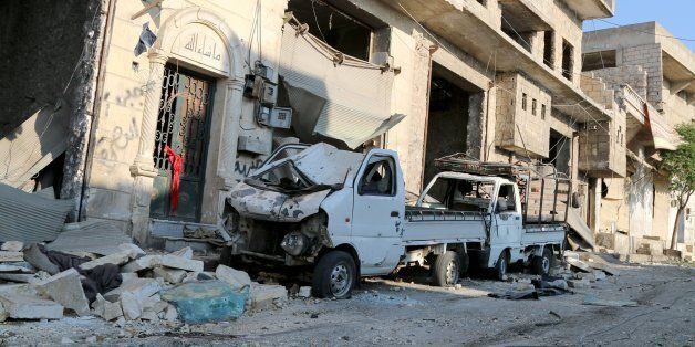 ALEPPO, SYRIA - AUGUST 7: A damaged vehicle is seen after a helicopter belonging to Syrian army hit the residential area with barrel bombs, which have explosive hoses, in Aleppo's Darat Izza district, Syria on August 7, 2016. (Photo by Alm Aldeen Al Sabbagh/Anadolu Agency/Getty Images)