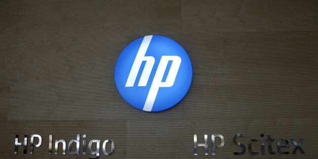 An illuminated logo sits on display beside 'HP Indigo' and 'HP Scitex' printer brands at Hewlett Packard Israel Ltd.'s 'Indigo' division production plant in Kiryat Gat, Israel, on Sunday, Sept. 15, 2013. Hewlett-Packard Co. Chief Executive Officer Meg Whitman is working to shift operations toward the biggest trends in technology such as tablets and a move to online computing services while making its printers and ink more affordable. Photographer: Ariel Jerozolimski/Bloomberg via Getty Images