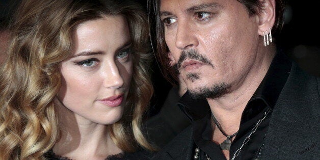 Cast member Johnny Depp and his actress wife Amber Heard arrive for the British premiere of the film