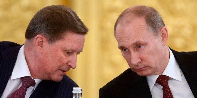 Kremlin's Chief of Staff Sergei Ivanov, left, speaks to Russian President Vladimir Putin during a Council of Physical Fitness and Sports in the Kremlin in Moscow, Russia, Monday, March 24, 2014. (AP Photo/RIA-Novosti, Alexei Nikolsky, Presidential Press Service)