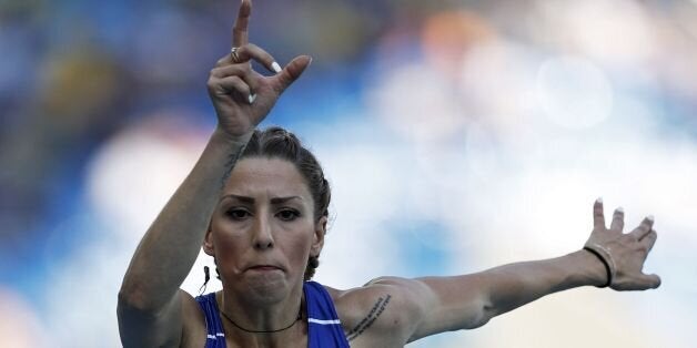 Greece's Paraskevi Papachristou competes in the Women's Triple Jump Qualifying Round during the athletics event at the Rio 2016 Olympic Games at the Olympic Stadium in Rio de Janeiro on August 13, 2016. / AFP / Adrian DENNIS (Photo credit should read ADRIAN DENNIS/AFP/Getty Images)