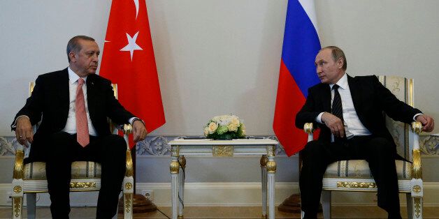 Russian President Vladimir Putin, right, and Turkish President Recep Tayyip Erdogan talk during their meeting in the Konstantin palace outside St.Petersburg, Russia, on Tuesday, Aug. 9, 2016. President Erdogan travels to Russia to meet with President Putin for the first time since apologizing in late June for the downing of a Russian fighter jet along the Syrian border in November last year. (AP Photo/Alexander Zemlianichenko)