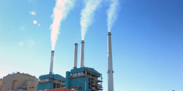 FILE - This July 1, 2013 file photo smoke rises from the Colstrip Steam Electric Station, a coal burning power plant in in Colstrip, Mont. The Supreme Court on Monday placed limits on the sole Obama administration program already in place to deal with power plant and factory emissions of gases blamed for global warming. The justices said that the Environmental Protection Agency lacks authority in some cases to force companies to evaluate ways to reduce carbon dioxide emissions. This rule applies when a company needs a permit to expand facilities or build new ones that would increase overall pollution. Carbon dioxide is the chief gas linked to global warming. (AP Photo/Matthew Brown, File)