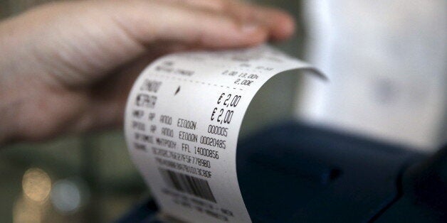 A waitress issues a receipt at a cafe in Athens, Greece, June 25, 2015. Monthly reports by Greece's financial crimes units highlight just how common tax dodging is, from doctors to farmers to contractors and civil servants. That, and the prevalence of small- and medium-sized businesses and the self-employed, as well as the sizeable shadow economy, shows just how difficult it is to crack down on Greece's corruption and tax evasion, which leftist Prime Minister Alexis Tsipras has made one of his p