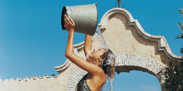 Woman Pouring a Bucket of Water Over Her Head