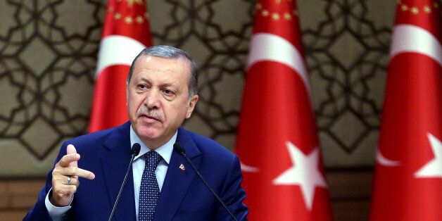 Turkey's President Recep Tayyip Erdogan speeches to the heads of chambers of commerce in Ankara, Turkey, on Thursday, Aug. 4, 2016. Erdogan vowed to go after businesses linked to a US-based Muslim cleric he accuses of having been behind Turkey's failed July 15 coup. The Turkish government characterizes the movement of Fethullah Gulen, who lives in self-imposed exile in Pennsylvania, as a terrorist organization. (Kayhan Ozer/Presidential Press Service, Pool Photo via AP)