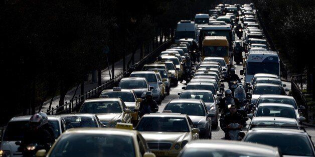 Vehicles are stuck in traffic on a main road leading to the center of Athens on January 22, 2013, due to a strike of the metro employees. Striking subway workers in Athens defied a court order to return to work and continued their protest for a sixth day to protest against salary cuts that are part of the new round of the austerity measures. AFP PHOTO / ARIS MESSINIS (Photo credit should read ARIS MESSINIS/AFP/Getty Images)