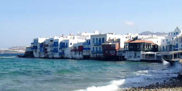 This July 6, 2014 photo shows homes tucked into the waterfront of the island of Mykonos, in an area known as Little Venice. Mykonos is located in the Cyclades, a Greek island chain in the Aegean Sea. The Cyclades are known for panoramic views of the sea, homes tucked into cliffsides and waterfronts, black-sand beaches and dramatic sunsets. (AP Photo/Kristi Eaton)