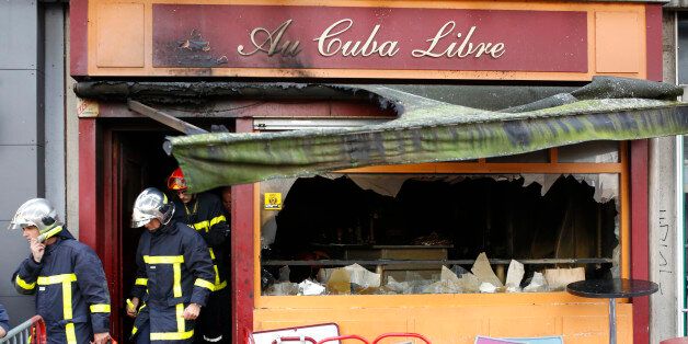 Firefighters leave the bar where a fire broke in Rouen, western France, Saturday Aug.6, 2016. A fire swept through a Friday night birthday party at a bar in the Normandy city of Rouen, killing at least 13 people and injuring six others, French authorities said. (AP Photo/Kamil Zihnioglu)