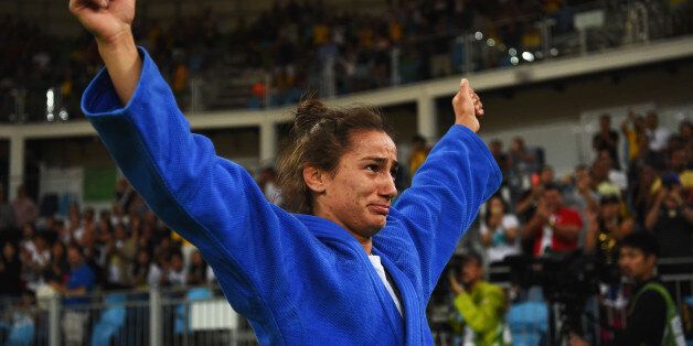 RIO DE JANEIRO, BRAZIL - AUGUST 07: Majlinda Kelmendi of Kosovo (blue) shows her emotions as she celebrates winning the gold medal against Odette Giuffrida of Italy during the WomenÂs -52kg gold medal final on Day 2 of the Rio 2016 Olympic Games at Carioca Arena 2 on August 7, 2016 in Rio de Janeiro, Brazil. (Photo by Laurence Griffiths/Getty Images)