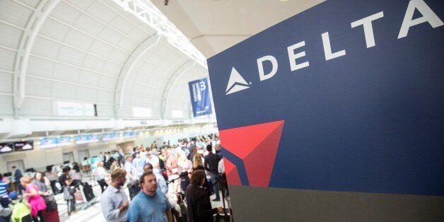 TORONTO, CANADA - AUGUST 8, 2016 : People mill around while passengers await updates from Delta airline...