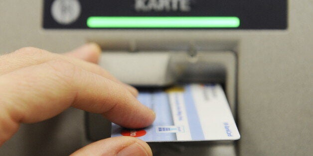 A German debit card is seen in the slot of an ATM in Berlin January 5, 2010. Around 20 million German debit cards and 3.5 million credit cards have been hit by a software bug related to adapting to the new year, the country's savings bank association said January 5.AFP PHOTO / JOHN MACDOUGALL (Photo credit should read JOHN MACDOUGALL/AFP/Getty Images)