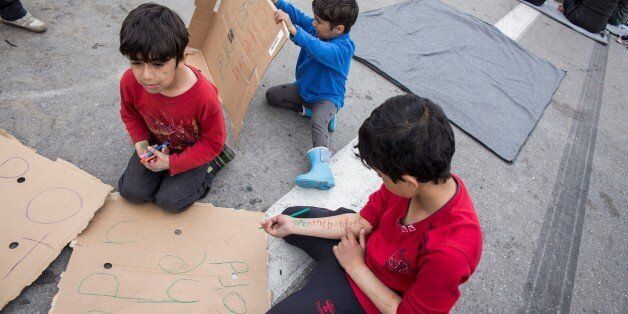 KILKIS, GREECE - APRIL 3: Refugee children prepare banners for the protests in EKO station at Polykastro town in Kilkis, Greece on April 3, 2016. (Photo by RoberAstorgano/Anadolu Agency/Getty Images)