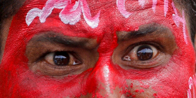 A member of India's low-caste Dalit community shouts slogans at a rally to protest against the attack on their community members in Ahmadabad, India, Sunday, July 31, 2016.Dalits have been protesting after four men belonging to their community were beaten while trying to skin a dead cow in Una in western Gujarat state early this month. The writing in Gujarati on his face hails Dalit leader Bhim Rao Ambedkar. (AP Photo/Ajit Solanki)