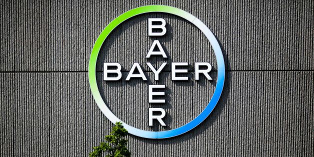 The Bayer AG corporate logo is displayed on a building of the German drug and chemicals company in Berlin, Germany, Monday, May 23, 2016. German drug and chemicals company Bayer AG announced Monday, May 23, 2016 that it has made a US$ 62 billion offer to buy U.S.-based crops and seeds specialist Monsanto. The proposed combination would create a giant seed and farm chemical company with a strong presence in the U.S., Europe and Asia. (AP Photo/Markus Schreiber)