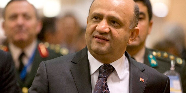 Turkish Defense Minister Fikri Isik, center, arrives for a meeting at NATO headquarters in Brussels on Tuesday, June 14, 2016. NATOâs chief says the alliance will agree this week to send four multinational battalions to the Baltic states and Poland to boost their defenses against Russia. (AP Photo/Virginia Mayo, Pool)