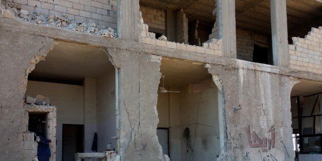 IDLIB, SYRIA - JULY 28: Debris of a collapsed building of a blood bank is seen after Russian forces' air-strike over residential areas in Saraqib District of Idlib, Syria on July 28, 2016. At least 4 employees killed. (Photo by Abdurrahman Hidir/Anadolu Agency/Getty Images)