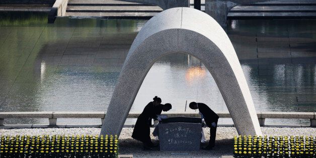FILE - In this Aug. 6, 2015 file photo, Kazumi Matsui, right, mayor of Hiroshima, and the family of the deceased bow before they place the victims list of the Atomic Bomb at Hiroshima Memorial Cenotaph during the ceremony to mark the 70th anniversary of the bombing at the Hiroshima Peace Memorial Park in Hiroshima, western Japan. Hiroshima city has asked the developer of âPokemon Goâ to remove the atomic bomb memorial park as a âgymâ location in the popular smartphone game. The city made the request Tuesday, July 26, 2016. It is asking game developer Niantic Inc. to delete the park from the game by Aug. 6, when an annual ceremony is held to remember those who died in the 1945 bombing. (AP Photo/Eugene Hoshiko, File)