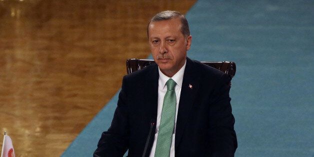 Turkey's President Recep Tayyip Erdogan waits to address a group of lawmakers from the ruling party at the parliament in Ankara, Turkey, Friday, July 22, 2016. Parliament voted 346-115 to approve the national state of emergency, which gives sweeping new powers to President Recep Tayyip Erdogan, who had been accused of autocratic conduct even before this week's crackdown on alleged opponents. Erdogan has said the state of emergency will counter threats to Turkish democracy. (AP Photo/Burhan Ozbilici)