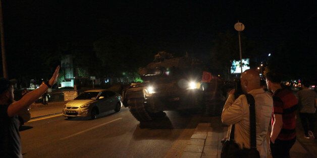 Tanks move into position as Turkish people attempt to stop them, in Ankara, Turkey, late Friday, July 15, 2016. Turkey's armed forces said it