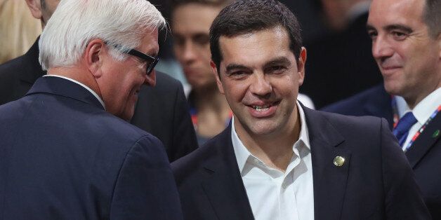 WARSAW, POLAND - JULY 08: Greek Prime Minister Alexis Tsipras (R) chats with German Foreign Minister Frank-Walter Steinmeier at the meeting of the North Atlantic Council at the Warsaw NATO Summit on July 8, 2016 in Warsaw, Poland. NATO member heads of state, foreign ministers and defense ministers are gathering for a two-day summit beginning today. (Photo by Sean Gallup/Getty Images)