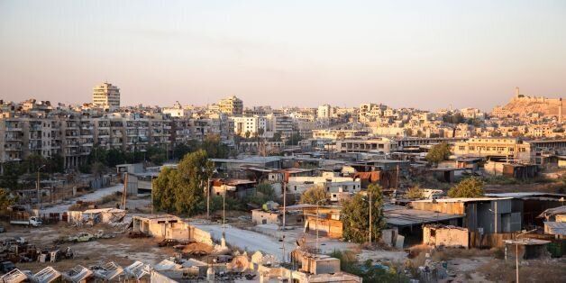 A picture taken on July 29, 2016 shows a general view of Karaj al-Hajz corridor (C) in the rebel-held part of Aleppo, leading towards the government controlled area of the Masharqa neighbourhood (background). Only a few residents of Syria's Aleppo were able to leave encircled opposition-held districts through humanitarian corridors before rebels prevented them from fleeing, the Syrian Observatory for Human Rights said on July 28, adding that Russia, a key ally of President Bashar al-Assad, on July 27 announced the opening of aid passages for civilians and surrendering fighters seeking to exit the city's rebel-held eastern neighbourhoods but regime aircraft bombed eastern areas of Aleppo overnight. / AFP / KARAM AL-MASRI (Photo credit should read KARAM AL-MASRI/AFP/Getty Images)