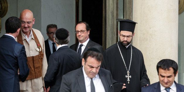 French President Francois Hollande, center, talks to the Great Rabbi of France Haim Korsisa, back to the camera, after a meeting with religious representatives following yesterday attack at a church in Normandy, Wednesday, July 27, 2016. The Islamic State group crossed a new threshold Tuesday in its war against the West, as two of its followers targeted a church in Normandy, slitting the throat of an elderly priest celebrating Mass and using hostages as human shields before being shot by police. Other identified people are : Paris Mosque rector, Dalil Boubakeur, left, and vice-president of the French Council of the Muslim Faith, Ahmet Ogras, right. (AP Photo/Thomas Padilla)