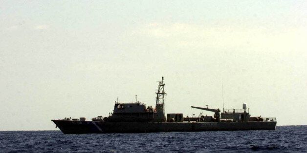 A Greek air force Hercules C130 flies over a coast guard vessel and a Greek Navy Frigate which are as they search for bodies and wreckage of the Greek army helicopter which crashed on the Aegean sea, some 5.5 miles ( nine kilometers) south west of mount Athos in northern Greece on Sunday, Sept. 12, 2004. The Christian Orthodox Patriarch of Alexandria, Petros was killed Saturday after an army helicopter that was transporting him and his entourage to a monastic enclave in northern Greece crashed in the sea, according to the ministry of Defence and church officials. (AP Photo/Nikolas Giakoumidis)