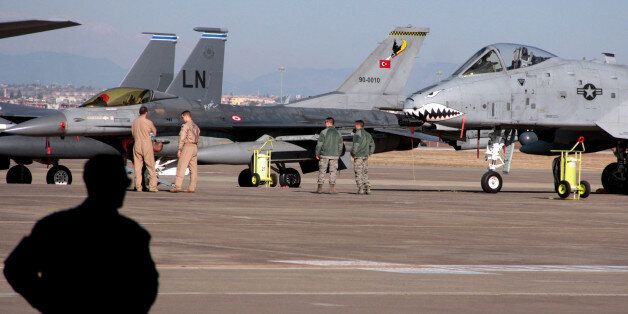 U. S. airmen stand next to the fighter jets after Defense Secretary Ash Carter visited the Incirlik Air Base near Adana, Turkey, Tuesday, Dec. 15, 2015. Carter said the U.S. wants Turkey to better control its border with Syria, which could help block the flow of foreign fighters to the Islamic State, and to more forcefully join the U.S.-led coalition
