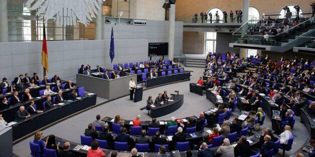 German Chancellor Angela Merkel, standing at the podium, addresses the German parliament Bundestag with a so-called Government Declaration about the British vote to leave the EU, in Berlin, Tuesday, June 28, 2016. (AP Photo/Markus Schreiber)