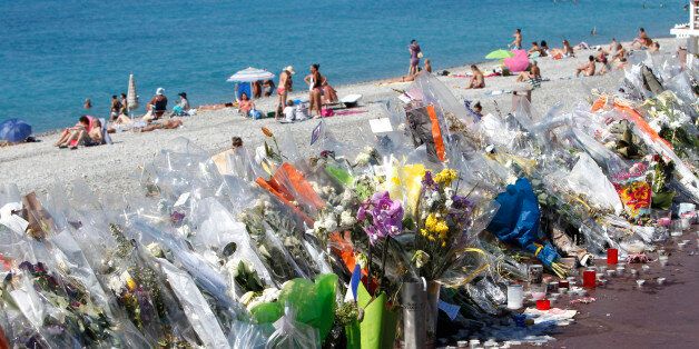 Flowers and messages are placed along the beach of the Promenade des Anglais in Nice, southern France, Wednesday, July 20, 2016. Joggers, cyclists and sun-seekers are back on Nice's famed Riviera coast, a further sign of normal life returning on the Promenade des Anglais where dozens were killed in last week's Bastille Day truck attack. (AP Photo/Claude Paris)