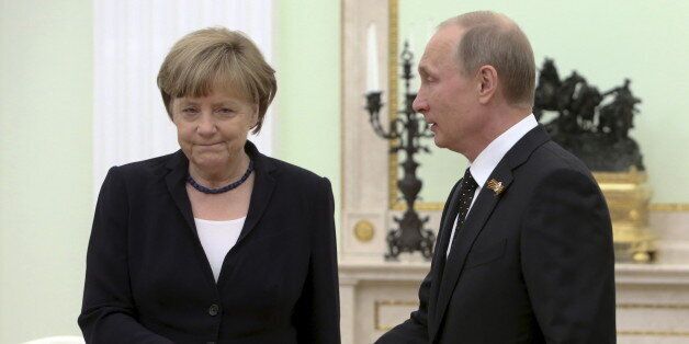 Russian President Vladimir Putin (R) approaches to shake hands with German Chancellor Angela Merkel during a meeting at the Kremlin in Moscow, Russia, May 10, 2015. Time magazine named Merkel its 2015