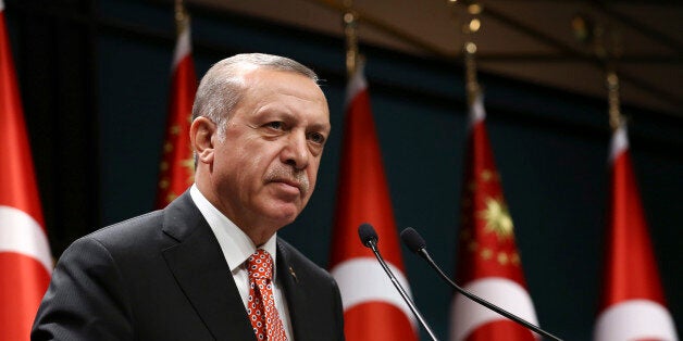 Turkey's President Recep Tayyip Erdogan, gestures during a televised address at the presidential palace in Ankara, Turkey, early Sunday July 24, 2016. ï»¿ï»¿Erdogan has sharply criticised concerns that the large-scale purges, which have left at least thousands of people in jail and about 50,000 fired or suspended, could jeopardise basic freedoms. Press Presidency Press Service via AP, Pool)