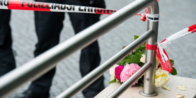MUNICH, GERMANY - JULY 23: Flowers layed by people outside the OEZ shopping center the day after a shooting spree left nine victims dead on July 23, 2016 in Munich, Germany. According to police an 18-year-old German man of Iranian descent shot nine people dead and wounded at least 16 before he shot himself in a nearby park. For hours during the spree and the following manhunt the city lay paralyzed as police ordered people to stay off the streets. Original reports of up to three attackers seem t