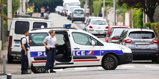 French police officers prevent the access to the scene of an attack in Saint Etienne du Rouvray, Normandy, France, Tuesday, July 26, 2016. Two attackers invaded a church Tuesday during morning Mass near the Normandy city of Rouen, killing an 84-year-old priest by slitting his throat and taking hostages before being shot and killed by police, French officials said. (AP Photo/Francois Mori)