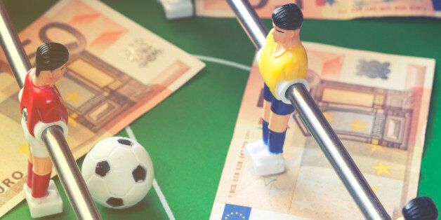 Sports and money. Concept about money spending in football (soccer), sports betting and manipulated fixed matches. Selective focus image cross processed for retro look