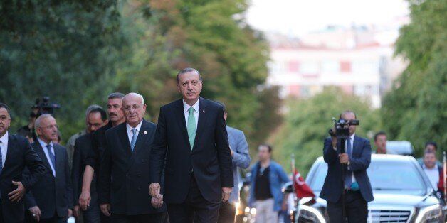 ANKARA, TURKEY - JULY 22: Turkey's President Recep Tayyip Erdogan (C) is welcomed by Speaker of the Turkish Parliament Ismail Kahraman (left 3) as he visits the Turkish parliament for the first time since it was bombed during the coup attempt on July 15, in Ankara, Turkey on July 22, 2016. During the country's failed deadly coup, the Grand National Assembly building was ripped apart by bombs and gunfire. (Photo by Aytac Unal/Anadolu Agency/Getty Images)