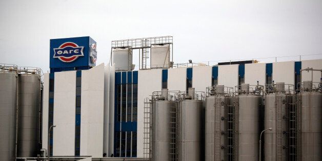 A Fage logo stands on display outside the Fage Dairy Industry SA plant in Athens, Greece, on Thursday, Feb. 21, 2013. An October restructuring that placed Fage International SA's Greek units in a subsidiary called Fage Dairy Industry SA coincided with Coca-Cola Hellenic Bottling SA's plan to flee the epicenter of Europe's debt crisis by moving its main stock listing to London from Athens. Photographer: Kostas Tsironis/Bloomberg via Getty Images