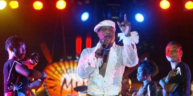 DAKAR, SENEGAL: Koffi Olomide from Congo and dancers of the Quarter Latin group, perform 30 April 2005 at the Iba Mar Diop stadium in Dakar during the Ebony Music Festival dedicated to the fight against malaria. AFP PHOTO SEYLLOU (Photo credit should read SEYLLOU/AFP/Getty Images)