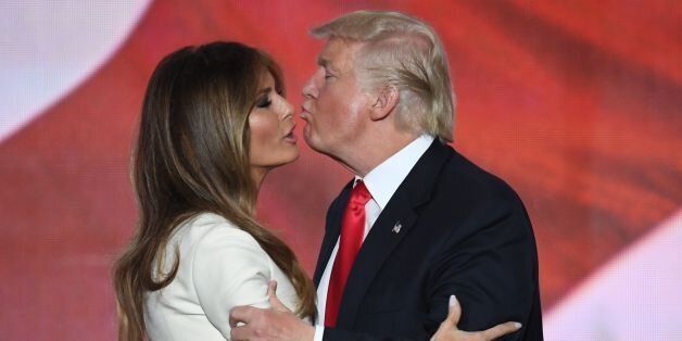 US Republican presidential candidate Donald Trump kisses his wife Melania on the final night of the Republican National Convention at the Quicken Loans Arena in Cleveland, Ohio on July 21, 2016. / AFP / Jim WATSON (Photo credit should read JIM WATSON/AFP/Getty Images)