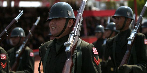 Turkish soldiers take part in the annual military parade, the highlight of celebrations marking the 42nd anniversary of the 1974 Turkish invasion, in the Turkish-controlled northern part of Nicosia in this ethnically divided island of Cyprus, on Wednesday, July 20, 2016. This year's parade was a muted affair with neither warplanes nor heavy battle tanks making an appearance following a decision by Turkish Cypriot leaders and army commanders to keep celebrations low key in the wake of the failed